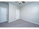 A minimalist bedroom featuring neutral walls, carpeted flooring, and a ceiling fan for added comfort at 9723 Flooded Field Dr, Ladson, SC 29456
