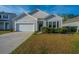 Inviting home exterior with tidy landscaping and a private driveway leading to an attached garage at 9723 Flooded Field Dr, Ladson, SC 29456
