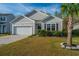 Charming single-Gathering home featuring a well-manicured front lawn and attached two-car garage at 9723 Flooded Field Dr, Ladson, SC 29456