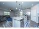 Open kitchen and living area with stainless steel appliances and a kitchen island with seating at 9723 Flooded Field Dr, Ladson, SC 29456