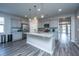Modern kitchen with granite countertops, stainless steel appliances, and stylish pendant lighting at 9723 Flooded Field Dr, Ladson, SC 29456