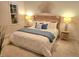 Serene bedroom with a wicker headboard, soft blue accents, and lamps on either side, creating a calming retreat at 102 Dandelion St, Summerville, SC 29483
