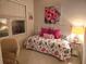 Bright bedroom with a daybed, pink accents, and a floral comforter, creating a cheerful and inviting atmosphere at 102 Dandelion St, Summerville, SC 29483