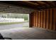 The inside of an empty garage shows a view of a neighborhood with a white picket fence at 102 Dandelion St, Summerville, SC 29483