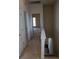 Hallway with carpet, leading to a door at the end, and stairs down to a lower level visible on the right at 102 Dandelion St, Summerville, SC 29483