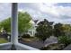 A view from a porch overlooking a street with multiple houses and trees at 102 Dandelion St, Summerville, SC 29483