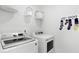 Neat laundry room with front loading washer, dryer, and humorous 