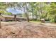 Expansive backyard featuring mature trees, fire pit, playground, grill, and ample space for recreation at 103 Arbor Rd, Summerville, SC 29485