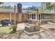 Inviting backyard with brick patio, fire pit, grill area, screened in porch, and hammock at 103 Arbor Rd, Summerville, SC 29485