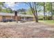 Large backyard with patio, grill, string lights, mature trees, and a hammock at 103 Arbor Rd, Summerville, SC 29485