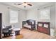 Bright Bedroom featuring hardwood floors, ceiling fan, rocking chair, crib, and changing table with ample storage at 103 Arbor Rd, Summerville, SC 29485