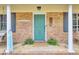 Welcoming front porch features charming decor, a cheerful blue door, and inviting curb appeal at 103 Arbor Rd, Summerville, SC 29485