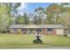 Charming brick home with blue shutters, manicured lawn, covered porch, and inviting curb appeal at 103 Arbor Rd, Summerville, SC 29485
