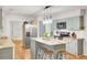 Well-lit kitchen with stainless steel appliances, island, and stylish pendant lights at 103 Arbor Rd, Summerville, SC 29485