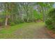 Spacious backyard with mature trees providing ample shade and privacy at 104 Huckleberry Ln, Summerville, SC 29485