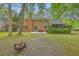 Large backyard showing brick home, patio area, and lush greenery at 104 Huckleberry Ln, Summerville, SC 29485
