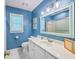 Blue bathroom featuring toilet, vanity with marble countertop, and a large framed mirror at 104 Huckleberry Ln, Summerville, SC 29485