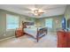 Comfortable bedroom with a wooden bed frame and ceiling fan, offering a serene retreat at 104 Huckleberry Ln, Summerville, SC 29485
