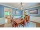 A well-lit dining room features a spacious table set for Gathering gatherings and entertaining at 104 Huckleberry Ln, Summerville, SC 29485