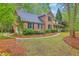 Charming brick and siding home with manicured lawn, fountain, and lush landscaping creating a serene setting at 104 Huckleberry Ln, Summerville, SC 29485