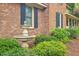 Close up of home's fountain feature, surrounded by manicured shrubs, brick, and siding at 104 Huckleberry Ln, Summerville, SC 29485