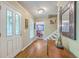Warm and inviting foyer features hardwood floors, decorative mirror, and plenty of natural light at 104 Huckleberry Ln, Summerville, SC 29485
