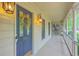 Inviting front porch with decorative wreath, charming lanterns, and exterior trim detail at 104 Huckleberry Ln, Summerville, SC 29485