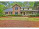 Charming brick home with inviting front porch and well-manicured lawn at 104 Huckleberry Ln, Summerville, SC 29485