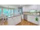 Bright and airy kitchen boasts white cabinets, stainless steel appliances, and a cozy breakfast nook at 104 Huckleberry Ln, Summerville, SC 29485
