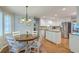 Open kitchen with stainless steel appliances, island, and dining nook with natural light at 104 Huckleberry Ln, Summerville, SC 29485