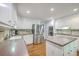 A bright kitchen featuring modern appliances and ample countertop space with white cabinetry at 104 Huckleberry Ln, Summerville, SC 29485