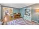 Open living room featuring hardwood floors, piano, and built-in shelving for storage at 104 Huckleberry Ln, Summerville, SC 29485