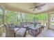Spacious screened porch featuring wicker furniture and serene backyard view at 104 Huckleberry Ln, Summerville, SC 29485