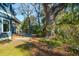Backyard with patio, outdoor seating area with fire pit, well-maintained lawn, and mature trees at 1056 Wharf Indigo Pl, Mount Pleasant, SC 29464