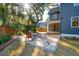 Backyard patio features pavers, a seating area with a fire pit, and a view of the home's exterior and well-manicured lawn at 1056 Wharf Indigo Pl, Mount Pleasant, SC 29464