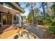 Backyard with paved patio, outdoor seating area with fire pit, wood deck, and view of lush landscaping at 1056 Wharf Indigo Pl, Mount Pleasant, SC 29464