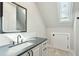 Elegant bathroom featuring a sleek countertop and a well-lit vanity area at 1056 Wharf Indigo Pl, Mount Pleasant, SC 29464
