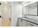 Modern bathroom boasts sleek vanity with dark hardware, framed mirror and a glass-enclosed shower at 1056 Wharf Indigo Pl, Mount Pleasant, SC 29464