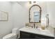 A modern bathroom vanity with quartz countertop, decorated mirror and decorative backsplash at 1056 Wharf Indigo Pl, Mount Pleasant, SC 29464