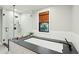 Clean and modern bathroom featuring a soaking tub and frameless glass shower with black hardware at 1056 Wharf Indigo Pl, Mount Pleasant, SC 29464