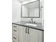 Modern bathroom boasts sleek vanity with dark hardware, framed mirror and a white backsplash at 1056 Wharf Indigo Pl, Mount Pleasant, SC 29464