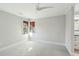 A spacious bedroom with neutral walls, carpet, windows with bamboo shades and a modern ceiling fan at 1056 Wharf Indigo Pl, Mount Pleasant, SC 29464