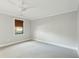 A spacious bedroom with neutral walls, carpet and a modern ceiling fan and window with natural lighting at 1056 Wharf Indigo Pl, Mount Pleasant, SC 29464