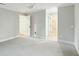 An open bedroom with neutral walls and white trim features, carpet and an open doorway to another room at 1056 Wharf Indigo Pl, Mount Pleasant, SC 29464