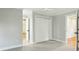 An open bedroom with neutral walls, carpet and an open doorway with white trim at 1056 Wharf Indigo Pl, Mount Pleasant, SC 29464
