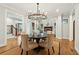Elegant dining area with a round table, plush chairs, and an open view to the living room at 1056 Wharf Indigo Pl, Mount Pleasant, SC 29464