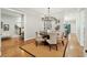 A modern dining room featuring a round table, stylish chairs, and hardwood flooring on top of a decorative rug at 1056 Wharf Indigo Pl, Mount Pleasant, SC 29464