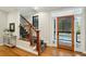 Welcoming entryway with hardwood floors, staircase, and stylish front door at 1056 Wharf Indigo Pl, Mount Pleasant, SC 29464