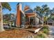 Beautiful blue house featuring a screened porch, wood accents, and mature trees surrounding the home at 1056 Wharf Indigo Pl, Mount Pleasant, SC 29464