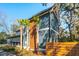 Exterior elevation showing the two-story home, unique trim, and small palm trees at 1056 Wharf Indigo Pl, Mount Pleasant, SC 29464